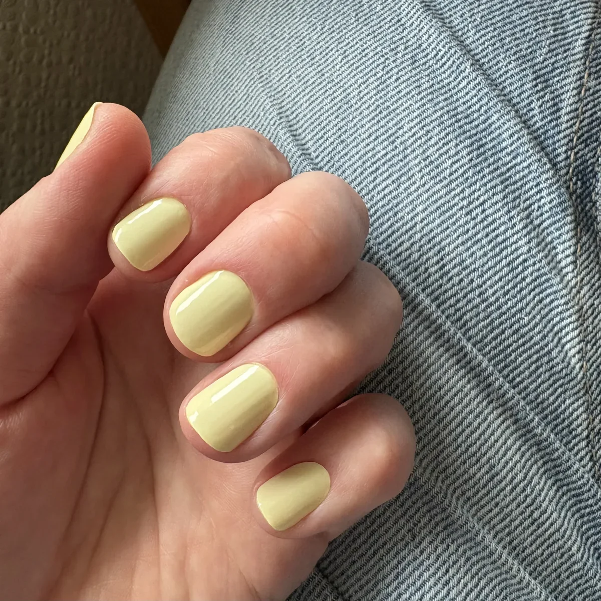 Butterfingers Glaize manicure resting on denim