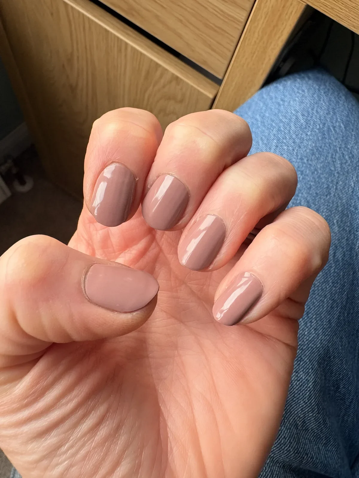 Chocolate Mousse Glaize manicure resting on denim