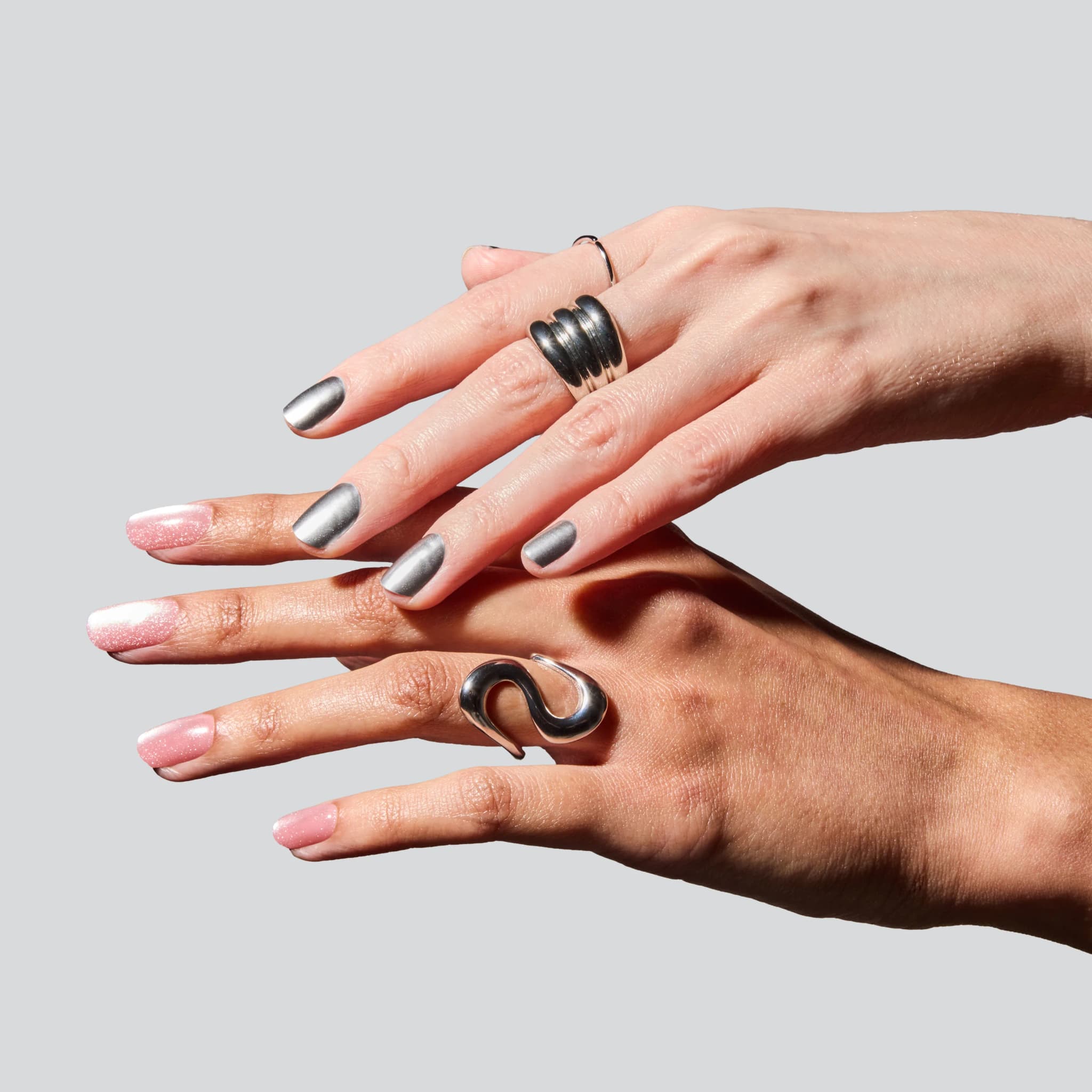A pair of hands wearing Glaize stick-on gel nails and press-on nails